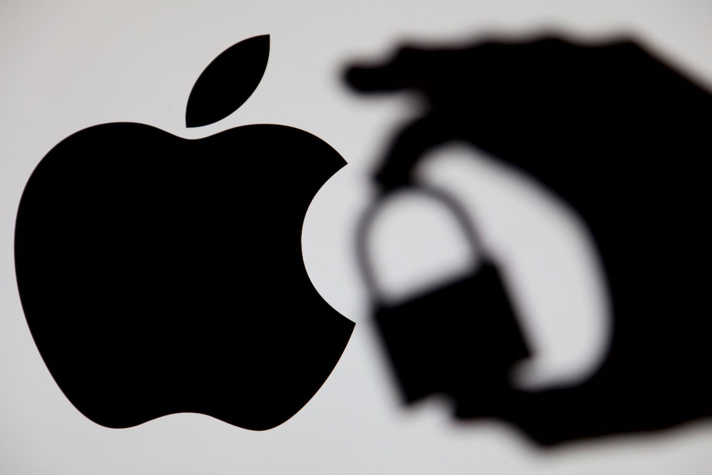 the Apple Logo with a Hand Holding a Lock.